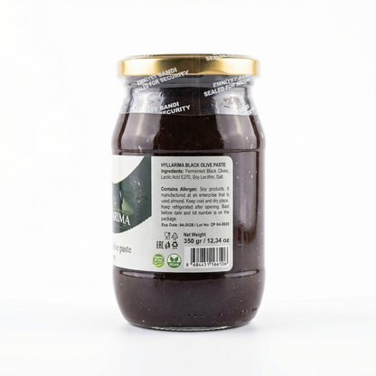 Jar of black olive paste with a visible label on a white background