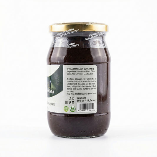Jar of black olive paste with a visible label on a white background