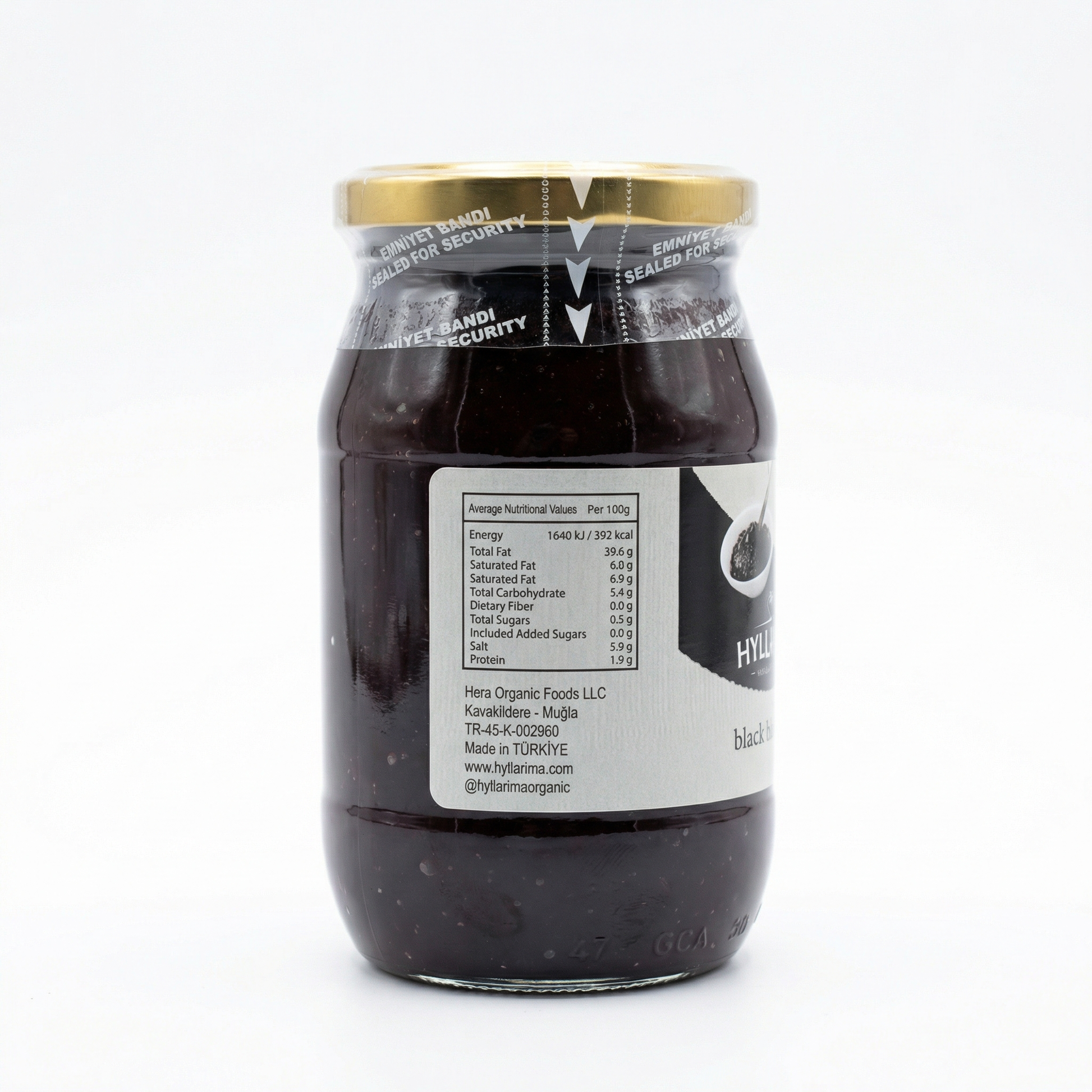 Jar of black olive spread with a visible label on a white background