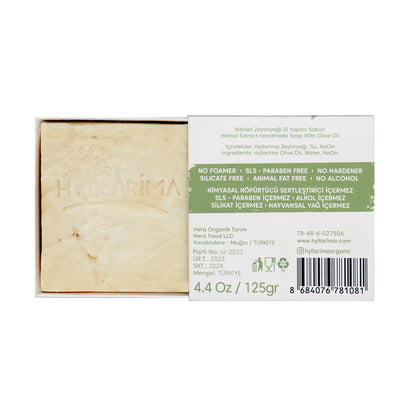 Bar of olive oil natural soap with a visible label on a white background