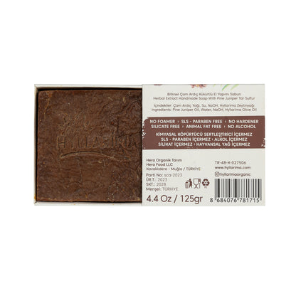 Bar of pine juniper natural soap with a label on a white background